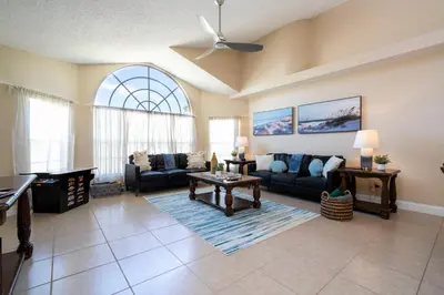a living room with a couch and a table at Beautiful, cozy and spacious Retreat near Disney in Kissimmee
