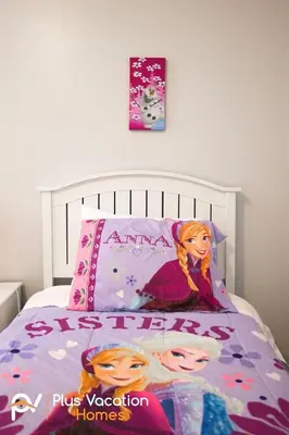 a bedroom with a bed with a disney princess pillow at 8503 Themed 7BD Villa- Game room Poolspa in Kissimmee