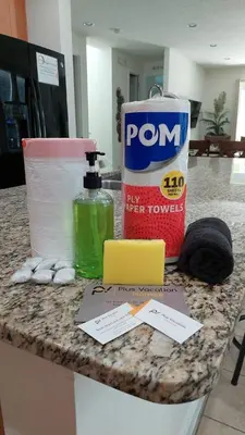a counter with a bottle of toilet paper and a bag of toiletries at 8503 Themed 7BD Villa- Game room Poolspa in Kissimmee
