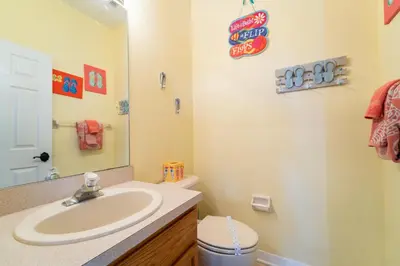 a bathroom with a sink and a toilet and a mirror at 16813GB Fun in the Sun in Orlando