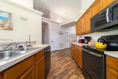 a kitchen with wooden cabinets and a sink at 16813GB Fun in the Sun in Orlando