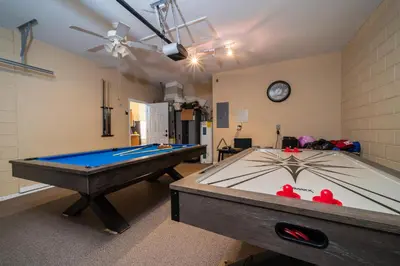 a room with a pool table and a clock on the wall at 16813GB Fun in the Sun in Orlando
