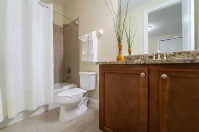 a bathroom with a toilet and a sink and a shower at 360LD Encore Magic Villa in Orlando