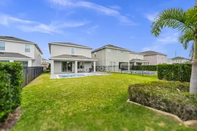 a yard with a house and a fence at Spectacular Home Near Disney With Private Pool And Waterpark & Resort Access At Encore Resorts Reunion - 465Sf in Kissimmee
