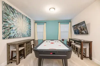 a room with a ping pong table and a pool table at Chic Home With Private Pool, Game Room And Waterpark & Resort Access Near Disney At Encore Resorts Reunion - 320Au in Kissimmee