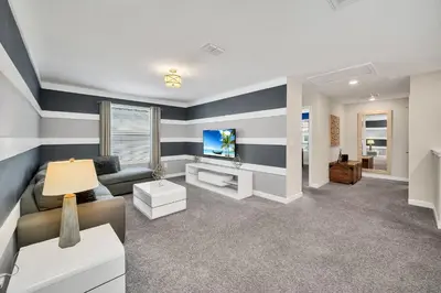 a living room with a couch and a tv at Gorgeous, Modern Home wPrivate Pool in Kissimmee