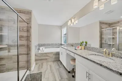 a bathroom with two sinks and a shower at Gorgeous, Modern Home wPrivate Pool in Kissimmee