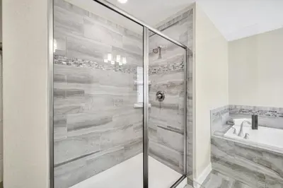 a shower with a glass door in a bathroom at Gorgeous, Modern Home wPrivate Pool in Kissimmee