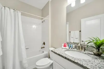 a white bathroom with a sink and a toilet at Gorgeous, Modern Home wPrivate Pool in Kissimmee