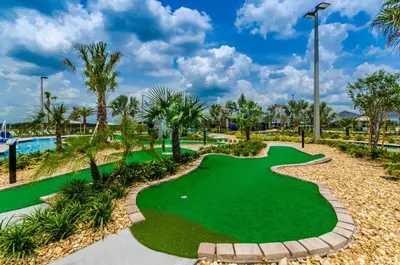 a miniature golf course at the resort with palm trees at NEW Magically Themed Condo w Pool View in Kissimmee
