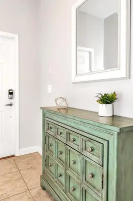 a green dresser with a mirror on top of it at In the heart of Kissimmee Storey Lake Resort 4BD 3BA Pool Townhome 4SL4857 in Kissimmee