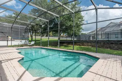a swimming pool with a clear cover over it at Spacious 4BR Home Themed Rooms, Pool, Near Disney in Orlando
