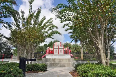 a red building in the middle of some trees at Spacious 4BR Home Themed Rooms, Pool, Near Disney in Orlando