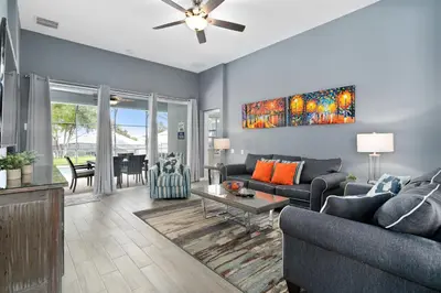 a living room with a couch and a table at Luxury 5BR Villa Near Disney, Private Pool & Game Room in Orlando