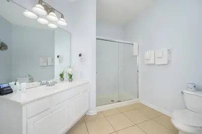 a white bathroom with a shower and a toilet at New Listing Beautiful Condo, Vista Cay - 3017 in Orlando