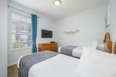 a bedroom with two beds and a window at New Listing Beautiful Condo, Vista Cay - 3017 in Orlando