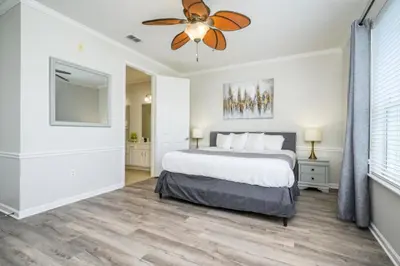 a bedroom with a bed and a ceiling fan at Epic Universe 4 Bedroom Plus, Lake View Condo, Vista Cay-1008 in Orlando