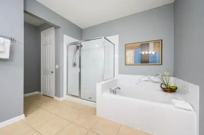 a bathroom with a white tub and a shower at Newly Renovated Premium Condo, Vista Cay - 2002 in Orlando