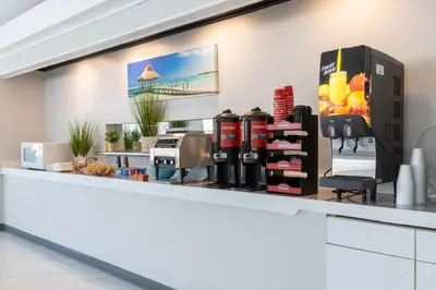 a counter in a coffee shop with a coffee machine at Motel 6 Altamonte Springs FL in Orlando