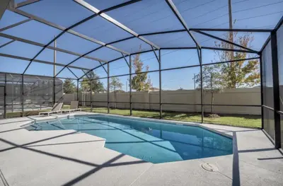 an indoor swimming pool with a glass roof at American Secret 10 BED 7 Miles to Disney in Kissimmee
