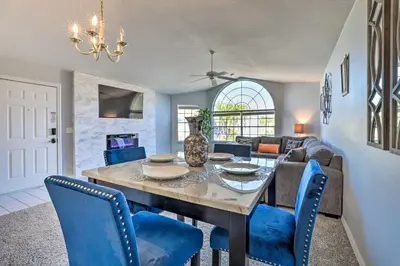 a dining room with a table and blue chairs at Less Than 8 Mi to Disney Getaway with Deck in Kissimmee! in Kissimmee