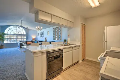 a large kitchen with a sink and a refrigerator at Less Than 8 Mi to Disney Getaway with Deck in Kissimmee! in Kissimmee