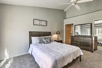 a bedroom with a bed and a dresser and a mirror at Less Than 8 Mi to Disney Getaway with Deck in Kissimmee! in Kissimmee