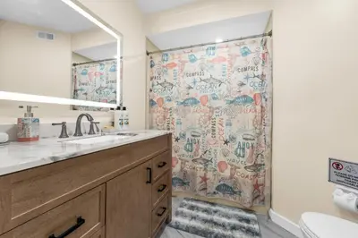 a bathroom with a shower curtain and a sink at Orlando Vacational Apartment 3919 in Orlando