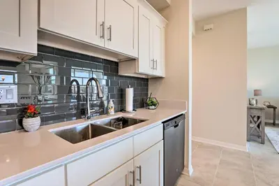 a kitchen with white cabinets and a sink at 6 Mi to Disney Resort Hideaway with Pool Access! in Kissimmee
