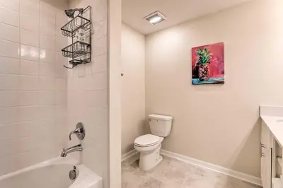 a bathroom with a toilet and a sink at 6 Mi to Disney Resort Hideaway with Pool Access! in Kissimmee