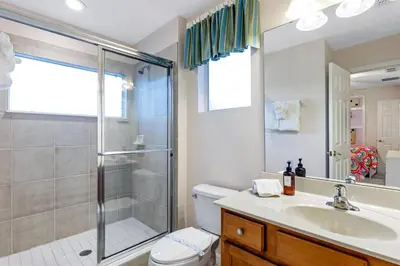 a bathroom with a shower and a toilet and a sink at South Facing Pool with Spa and Lake View in Gated Resort of Bella Vida Nr Disney in Kissimmee