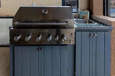 a blue kitchen with a sink and a stove at South Facing Pool with Spa and Lake View in Gated Resort of Bella Vida Nr Disney in Kissimmee