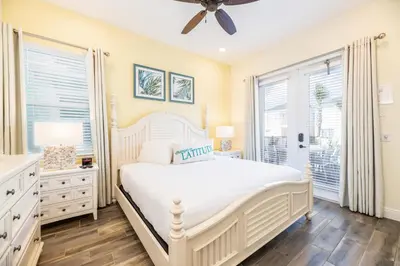 a white bedroom with a bed and a window at Mango Breeze Cottage With Private Pool Near Disney With Margaritaville Resort And Island H20 Waterpark Access - 2910Sr in Orlando