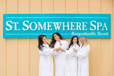 a group of women in white robes standing in front of a sign at Blue Sky Cottage Near Disney With Private Pool & Margaritaville Resort And Island H20 Waterpark Access - 2912Sr in Orlando
