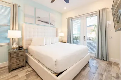 a bedroom with a large white bed and a window at Charming Cottage Near Disney With Margaritaville Resort & Island H20 Waterpark Access - 2918Sr in Orlando