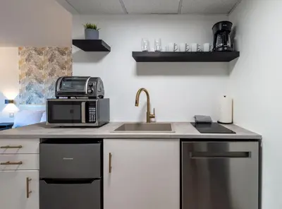 a kitchen counter with a microwave and a sink at NEW - remodeled Studio close to Universal Studios in Orlando