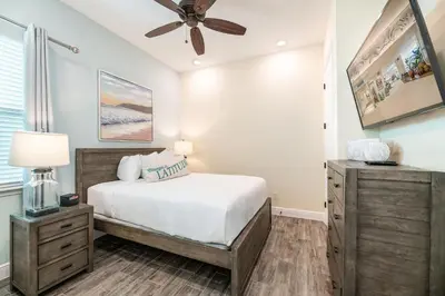 a bedroom with a bed and a ceiling fan at The Mermosa Cottage With Private Pool Near Disney With Margaritaville Resort & Island H2O Access - 8016St in Orlando