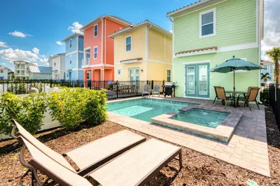a swimming pool with a bench and a house at Anchor Cottage With Private Pool Near Disney And Margaritaville Resort & Island H2O Access - 8020Kd in Orlando