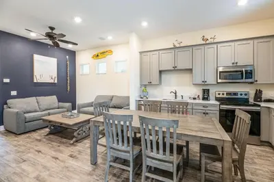 a kitchen and living room with a table and chairs at Anchor Cottage With Private Pool Near Disney And Margaritaville Resort & Island H2O Access - 8020Kd in Orlando