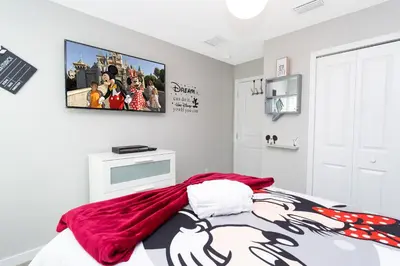 a bedroom with a red blanket on a bed at Gorgeous and New House at Le Reve Resort (214221) in Kissimmee