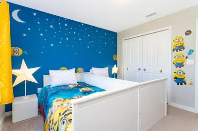 a childs bedroom with a blue wall at Gorgeous and New House at Le Reve Resort (214221) in Kissimmee