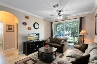 a living room with a couch and a table at Spacious 3 bed, 2 bath Condo in Gated Community condo in Kissimmee