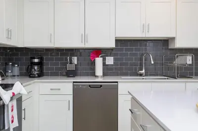 a kitchen with white cabinets and a stainless steel dishwasher at Gorgeous 3Bd 8 Guests @Storey Lake Resort Close to Disney 101 3191 in Kissimmee