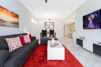 a living room with a couch and a red rug at Gorgeous 3Bd 8 Guests @Storey Lake Resort Close to Disney 101 3191 in Kissimmee