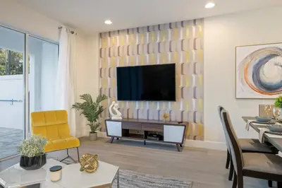 a living room with a television on a wall at Hidden Forest 3 Bedroom Vacation Home 2020 in Clermont