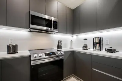 a kitchen with a stove and a microwave at Hidden Forest 3 Bedroom Vacation Home 2020 in Clermont