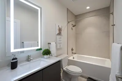 a bathroom with a tub and a toilet and a sink at Hidden Forest 3 Bedroom Vacation Home 2020 in Clermont