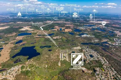 an aerial view of an island with buildings and water at Hidden Forest 3 Bedroom Vacation Home 2020 in Clermont