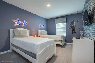 a bedroom with two beds and blue walls at Orlando Newest Resort Community Town Home townhouse in Orlando