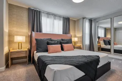 a bedroom with a large bed with two pillows at Formosa Valley by UNE Homes in Orlando